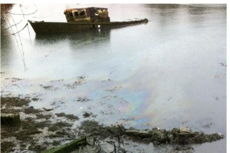 Abandoned boat with diesel pollution in water - photo credit TECF